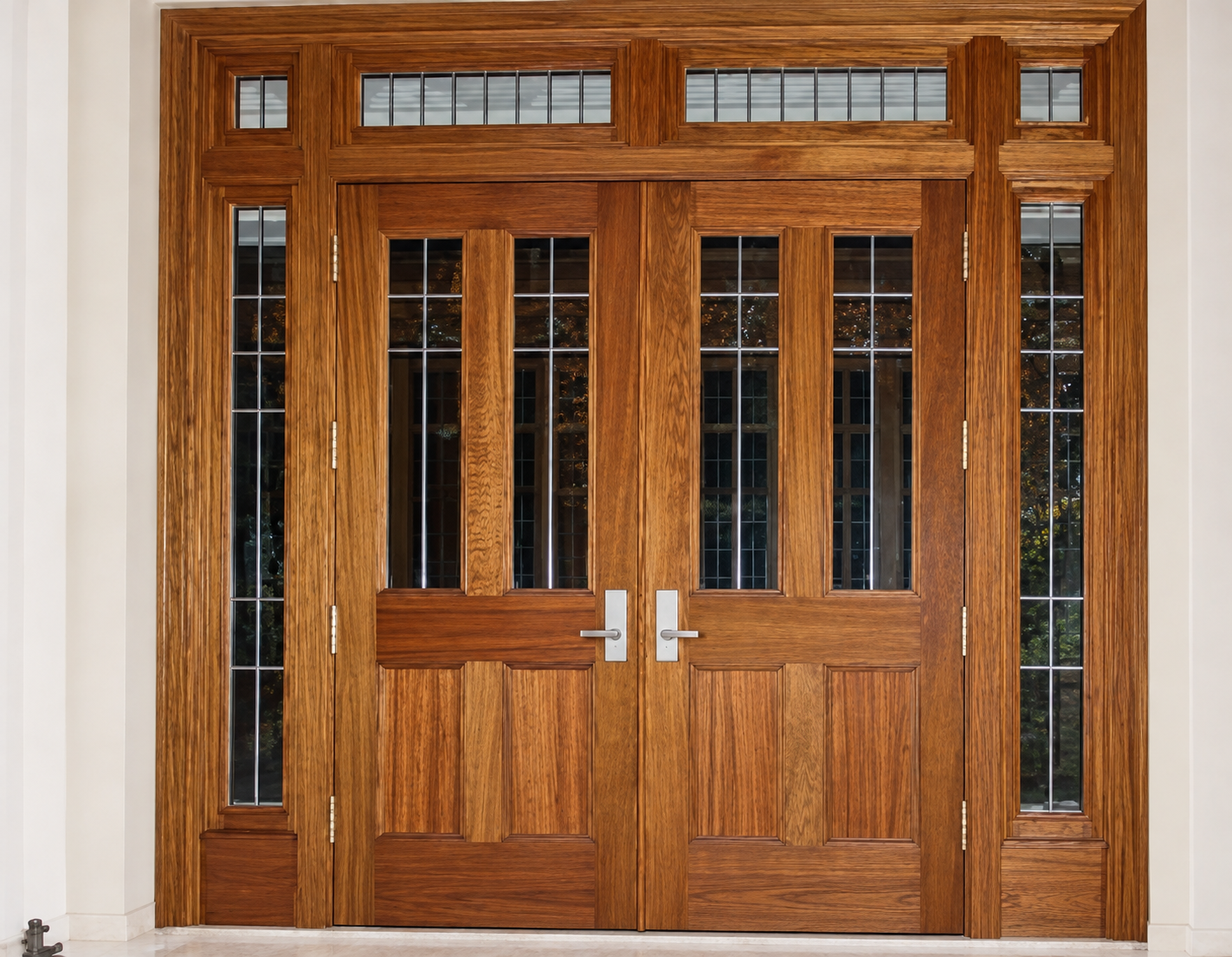 Detailed wood entry doors with divided-light windows and substantial trim