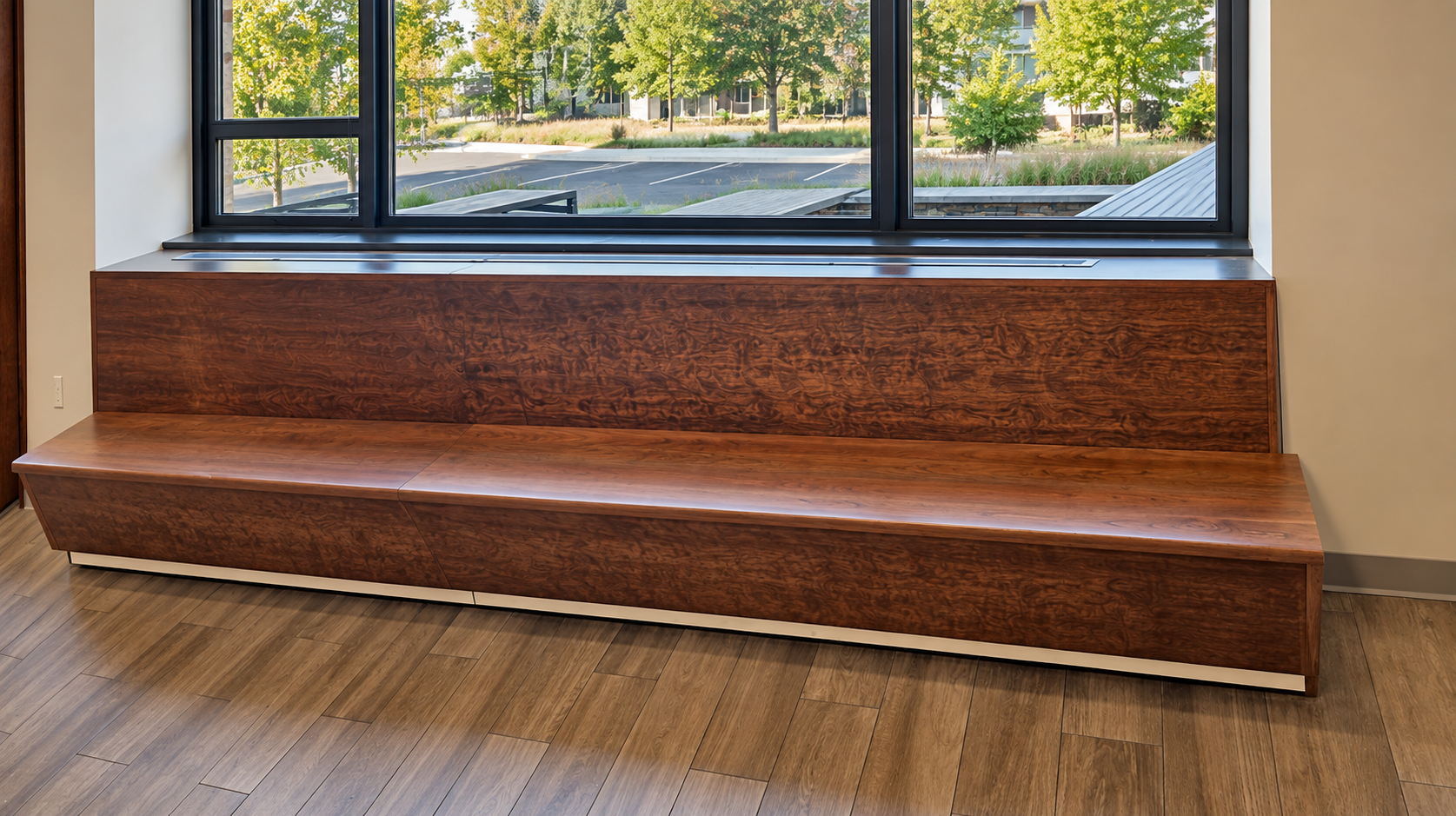 Custom wood window seat beneath a large bank of windows
